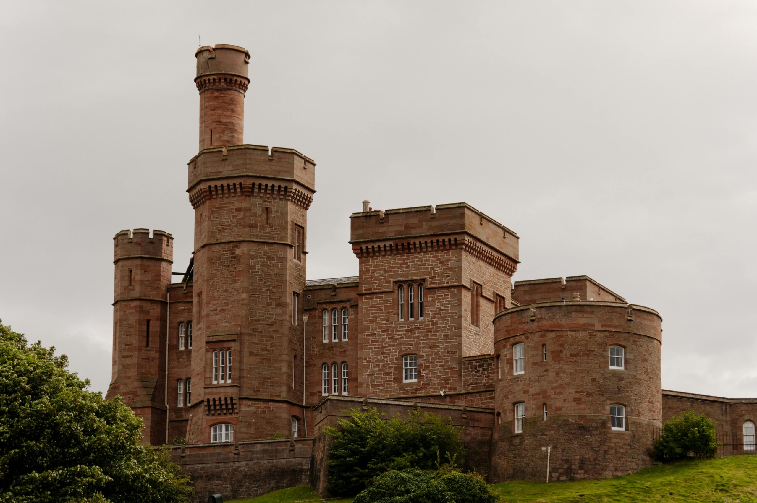 A view of the historic Inverness Castle in Scotland under overcast skies.